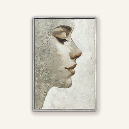 Neutral textured portrait wall art depicting a woman’s face in profile with a sleek silver frame.