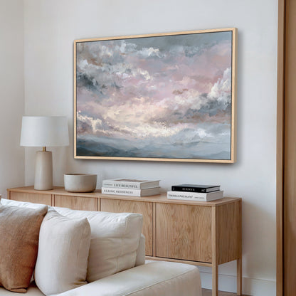 Ethereal pink sky wall art framed in light wood, styled in a modern living room.