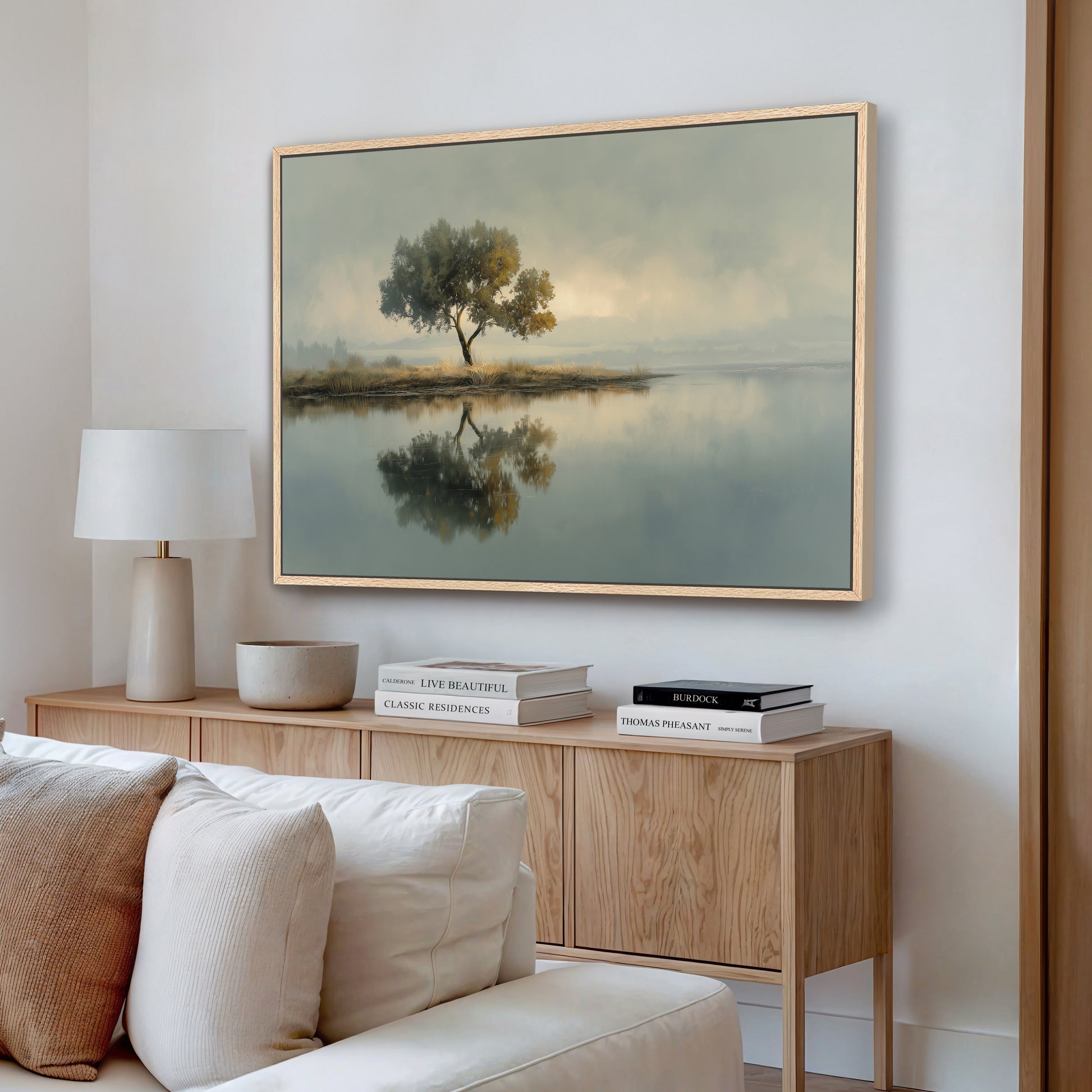 Tree landscape reflection canvas print displayed above console table