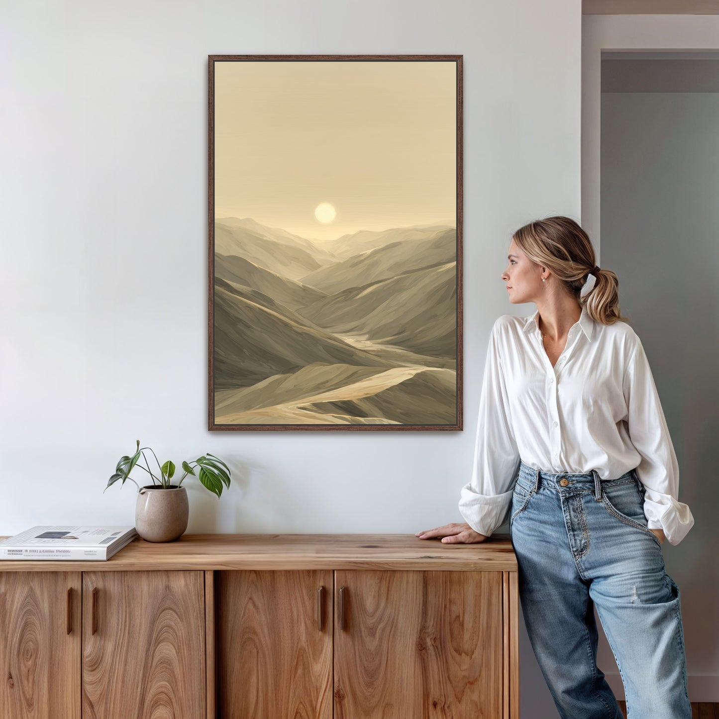 A woman viewing a large espresso framed canvas in living room.