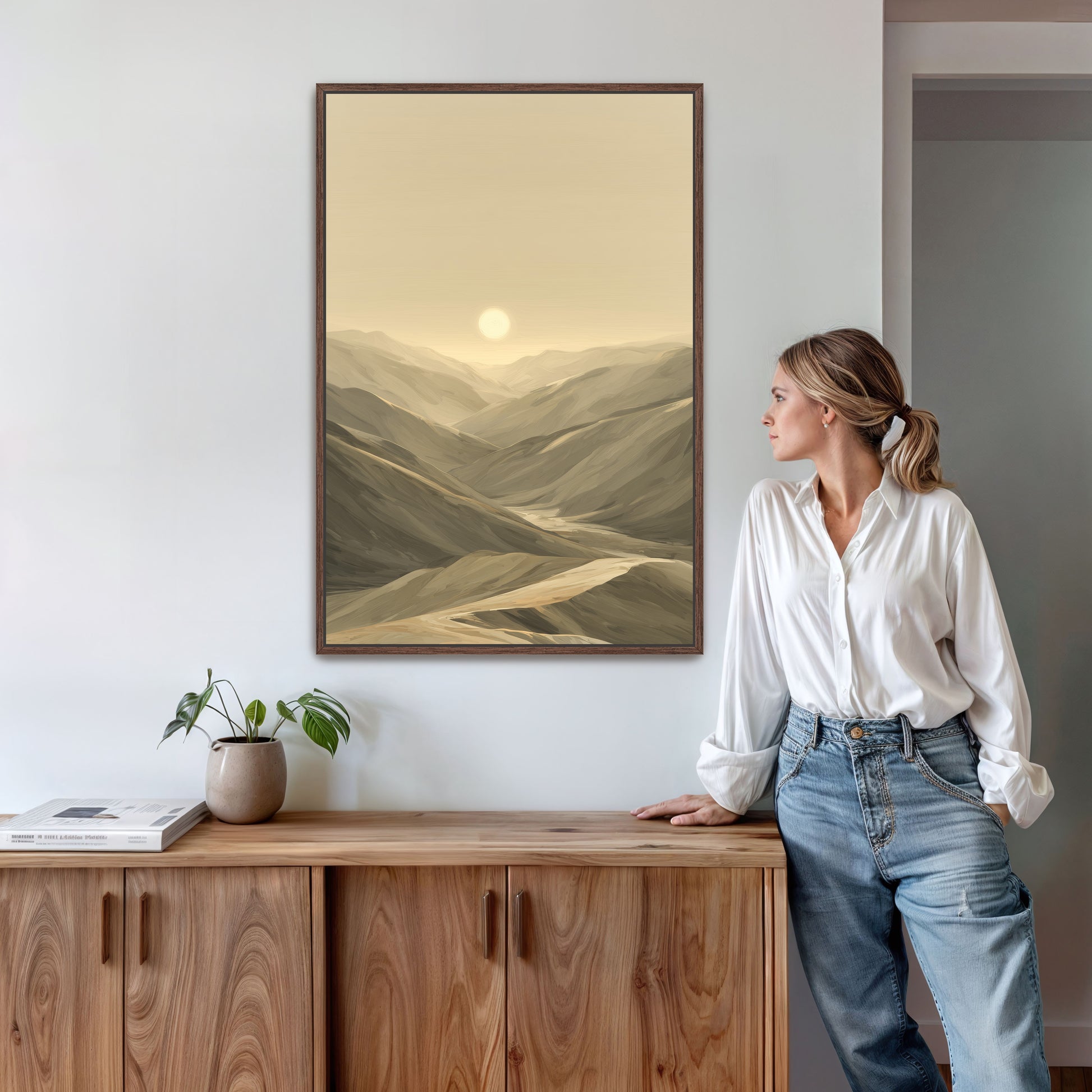 A woman viewing a large espresso framed canvas in living room.